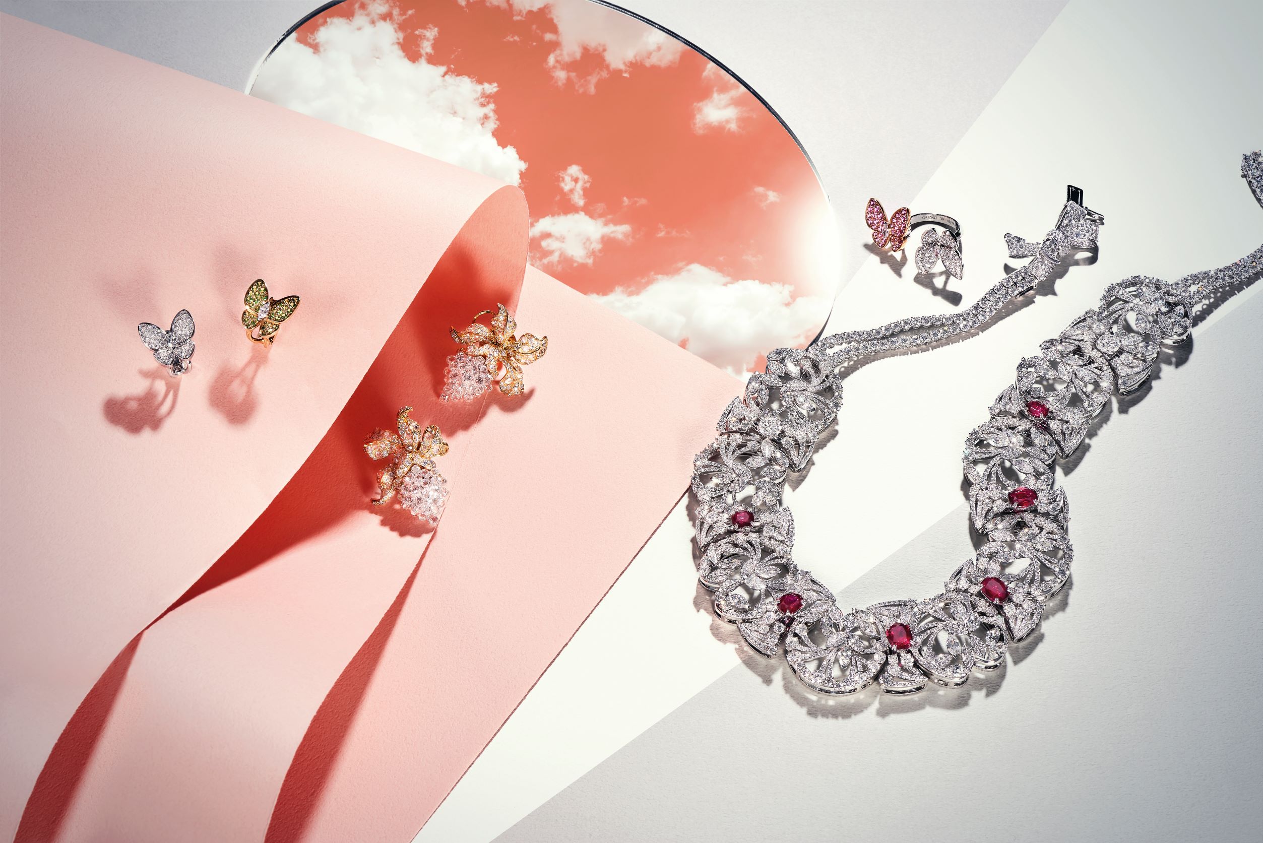 由左至右：Two Butterfly 黃 K 金鑲嵌石榴石與鑽石耳環，Van Cleef & Arpels；印象春蘭鑽石耳環，Anna Hu；Eternel Printemps 永恆春天 18K 白金鴿血紅寶石項鍊，Chaumet；Two Butterfly 粉紅剛玉與鑽石指間戒，Van Cleef & Arpels